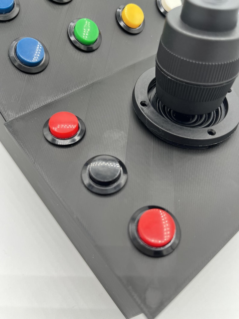 Close-up of momentary switches that accompany the joystick on the Farming Simulator button box, designed for realism and durable use.