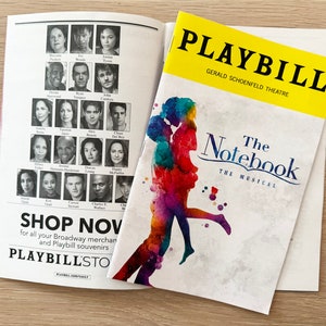 May include: A yellow and white Playbill for the musical "The Notebook" at the Gerald Schoenfeld Theatre. The cover features a watercolor-style illustration of a couple embracing.