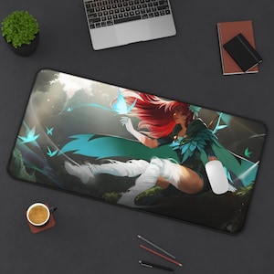 May include: A mousepad featuring a fantasy illustration of a woman with long red hair wearing a green and blue outfit with a butterfly design. The woman is sitting on a rock with a forest background.