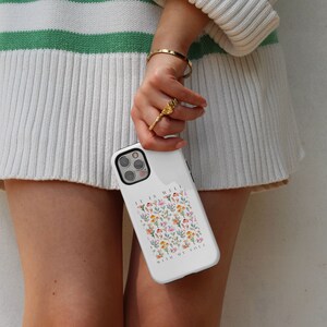 May include: White phone case with a floral pattern and the text "It is well with my soul".