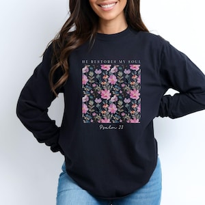 May include: Black long-sleeve shirt with a floral print and the text "He restores my soul, Psalm 23".