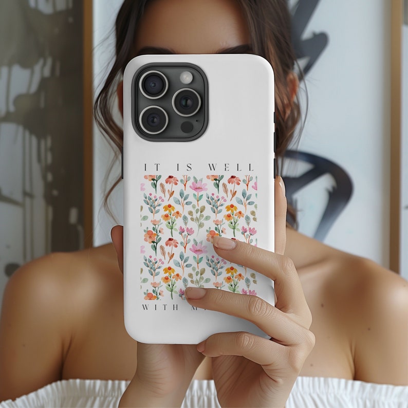 May include: White phone case with a floral pattern and the text "It is well with my soul".