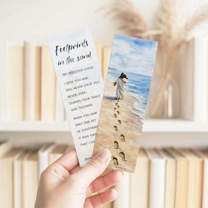 May include: Two bookmarks are held in a hand. One bookmark has the text "Footprints in the sand" and a poem. The other bookmark has a watercolour painting of two figures walking on a beach with footprints in the sand.
