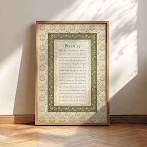 May include: A framed print of Psalm 23, with the text displayed centrally within a decorative border. The frame is light wood, and the background features a floral pattern. The overall style is vintage and religious.