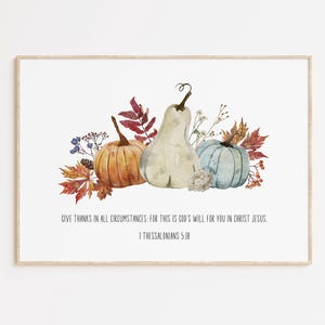 May include: A watercolor painting of gourds and fall foliage with the quote "Give thanks in all circumstances: for this is God's will for you in Christ Jesus. 1 Thessalonians 5:18"