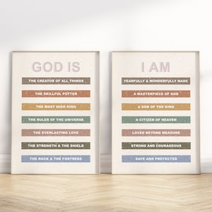 May include: Two beige framed prints with inspirational quotes. The left print says "God is" with a list of attributes in different coloured rectangles. The right print says "I am" with a list of attributes in different coloured rectangles.