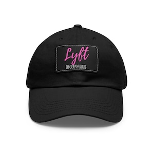 May include: Black cotton baseball cap with a pink patch that says "Lyft Driver" in a white rectangle.