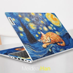 May include: A white laptop with a blue and yellow starry night design featuring a sleeping orange cat. The laptop has the Lenovo logo on the back.
