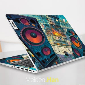 May include: A Lenovo laptop with a colourful, artistic design featuring large speaker graphics in shades of blue, orange, and purple. The laptop is open, displaying the keyboard and screen, with the Lenovo logo visible. The design covers the entire lid.