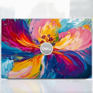 Puede incluir: Una piel para portátil con un diseño floral abstracto colorido con el logotipo de Dell en el centro.
