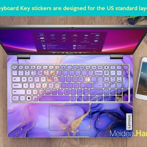May include: Purple and gold marble laptop keyboard stickers designed for a US standard keyboard layout. The stickers feature a swirling abstract design with gold accents. The stickers are shown on a laptop with a purple and gold marble design.