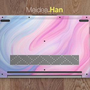 May include: The back of a laptop with a pink and blue marbled design. The laptop has a silver finish and a black speaker grill.