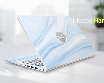 May include: A white laptop with a blue marble design on the lid. The Dell logo is visible on the lid. The laptop is open and the keyboard is visible.