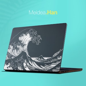 May include: A dark grey laptop skin featuring a white line art illustration of a large crashing wave and a small boat. The text Meidea.Han is printed in white and yellow above the laptop. The laptop is shown at an angle against a solid teal background.
