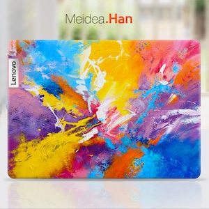 Könnte beinhalten: Ein farbenfrohes abstraktes Design mit Spritzern von gelber, blauer, rosa, violetter und weißer Farbe. Das Design befindet sich auf einer Laptop-Hülle mit dem Wort "Lenovo" auf der Seite.