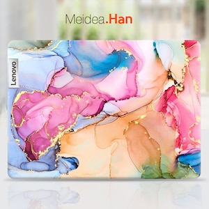 May include: A laptop skin with an abstract design featuring pink, blue, and gold swirls. The skin has the word "Lenovo" printed on the left side.