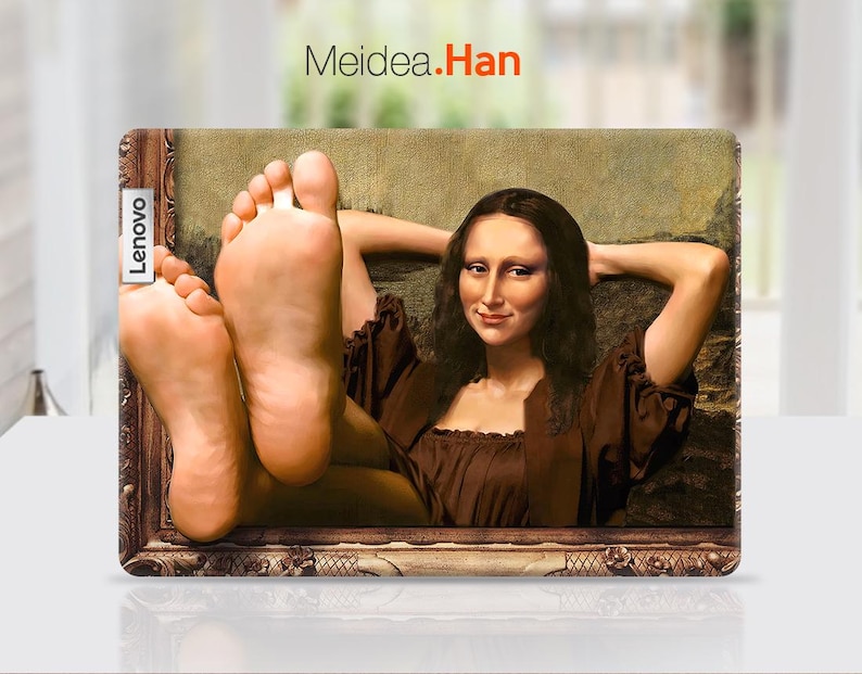 May include: A laptop skin featuring a painting of a woman with long brown hair, wearing a brown dress, and resting her head on her hands. The woman's feet are visible in the bottom of the frame. The skin has a gold frame and the text "Meidea.Han" is printed at the top. The text "Lenovo" is printed on the left side of the skin.