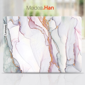 May include: A white laptop skin with a marble pattern in shades of pink, green, and gold. The skin has the word "Lenovo" printed on the left side.
