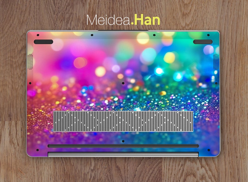 May include: A laptop with a colorful glitter and bokeh background. The laptop has a silver finish and a black vent.