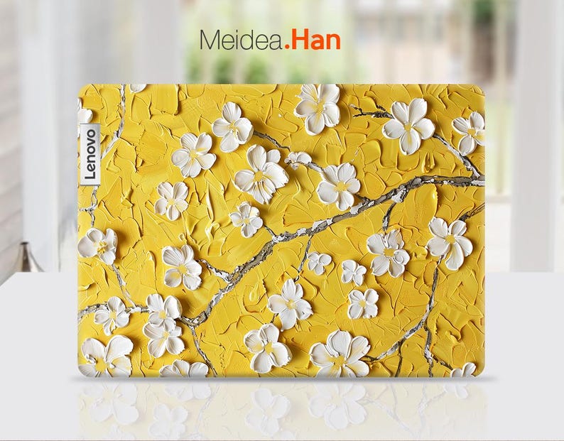 May include: A yellow laptop skin with a white floral design. The skin has the word "Lenovo" printed on the left side.