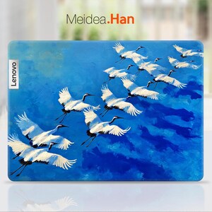 May include: A Lenovo laptop case featuring a painting of white cranes in flight against a vibrant blue sky. The artwork includes the text "Meidea.Han" and the Lenovo logo.