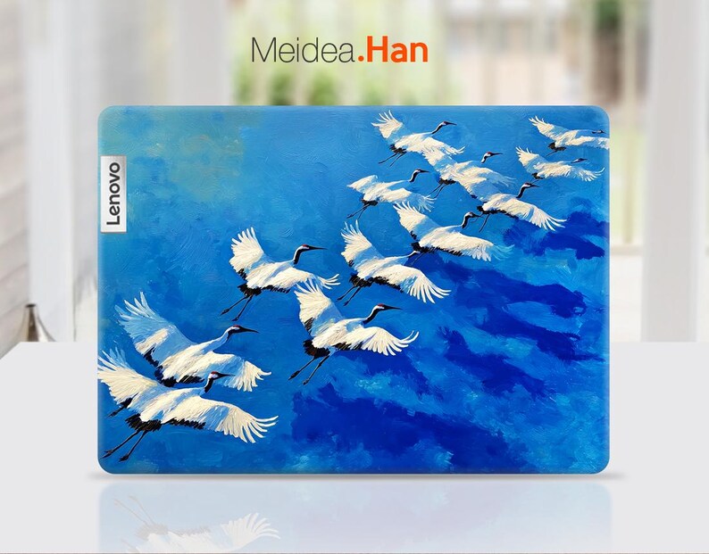 May include: A Lenovo laptop case featuring a painting of white cranes in flight against a vibrant blue sky. The artwork includes the text "Meidea.Han" and the Lenovo logo.