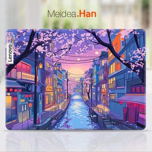 May include: A colourful laptop skin featuring a cityscape and cherry blossom trees. The skin has a purple, pink and blue colour scheme with a canal running through the centre of the image. The text "Lenovo" is visible in the top left corner of the image.