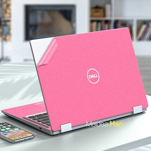 May include: A pink laptop skin with a white Dell logo. The skin has a sparkly texture.