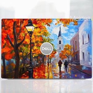 May include: A colorful painting of a city street scene with a church in the background. The street is lined with trees with orange, yellow, and red leaves. There is a street lamp in the foreground and two people walking down the street. The painting has a Dell logo in the center.