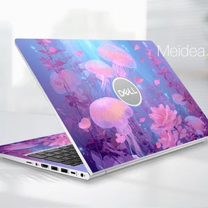 May include: A Dell laptop with a custom skin featuring a vibrant underwater scene. The design includes pink jellyfish, flowers, and aquatic plants against a blue and purple gradient background. The Dell logo is visible. Text on the laptop reads "Meidea.Han".