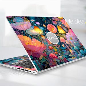 Può includere: Un laptop Dell con un vivace motivo floreale. Il coperchio e l'area della tastiera del laptop sono ricoperti di fiori colorati nei toni del rosa, arancione, giallo e blu. Il testo "Meidea.Han" è visibile.