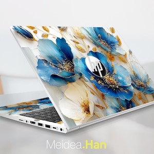May include: A white HP laptop with a floral design featuring blue and gold flowers. The laptop is open, displaying the keyboard and screen, with the HP logo visible. The text "Meidea.Han" is at the bottom.