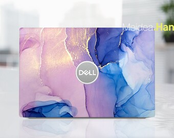 May include: A laptop skin with a purple and blue abstract design featuring gold accents. The Dell logo is visible in the centre of the skin.