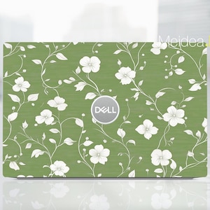 May include: Green laptop skin with a white floral pattern and the word "DELL" in white on a circle in the center.