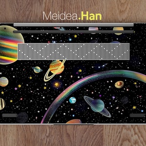 May include: A laptop skin with a space-themed design featuring planets, stars, and a rainbow. The design is on a black background.