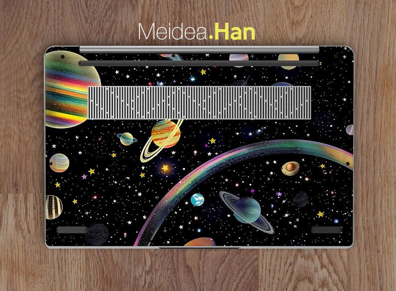 May include: A laptop skin with a space-themed design featuring planets, stars, and a rainbow. The design is on a black background.