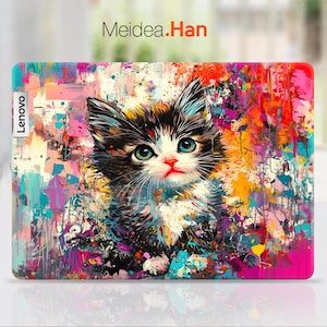 May include: A colorful abstract design laptop skin featuring a black and white cat with blue eyes. The design includes splashes of pink, orange, yellow, and blue paint. The skin has the word "Lenovo" printed on the left side.