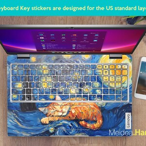 May include: A laptop keyboard with a starry night themed sticker set. The sticker set features a cat sleeping on a blue and yellow background with white stars. The keyboard is labeled "Lenovo".