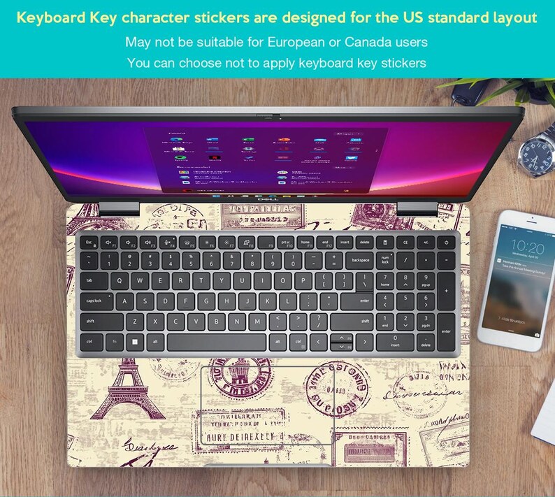 May include: A laptop computer with a keyboard sticker featuring a vintage Parisian theme. The sticker has a beige background with brown and purple stamps and a drawing of the Eiffel Tower. The text on the sticker reads "Q, W, E, R, T, Y, U, I, O, P, A, S, D, F, G, H, J, K, L, Z, X, C, V, B, N, M, Oilyuka, CIRATH, BURY DEIREXEY-4, FORUS".