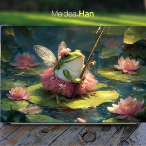 May include: A laptop skin with a fantasy illustration of a frog dressed as a fairy, fishing on a lily pad. The frog wears a pink tutu and has fairy wings. Pink water lilies and the text "Meidea.Han" are also visible.
