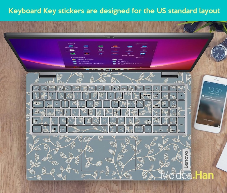 May include: A laptop with a floral keyboard skin. The keyboard keys are covered with stickers. The laptop is open, displaying a screen with a colorful interface. A smartphone and a watch are next to the laptop. The text "Keyboard Key stickers are designed for the US standard layout" is visible.