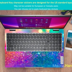 May include: A silver laptop computer with a colorful glitter keyboard sticker. The sticker features a gradient of pink, purple, blue, and green colors. The laptop is open and the screen is displaying a desktop with multiple icons. The text "Lenovo" is visible on the right side of the laptop. The text "Meidea.Han" is visible at the bottom of the image.