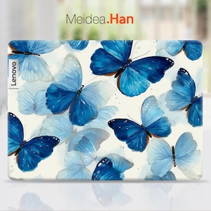 May include: A laptop case featuring a pattern of blue butterflies on a cream background. The butterflies vary in size and shade, with some appearing more translucent. The Lenovo logo is visible on the left side, and the text "Meidea.Han" is at the top.