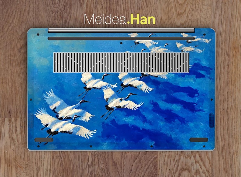 May include: Laptop skin featuring a vibrant blue sky with white cranes in flight. The design includes the text "Meidea.Han" at the top. The cranes are painted with detailed wings and black accents, creating a dynamic and artistic aesthetic.