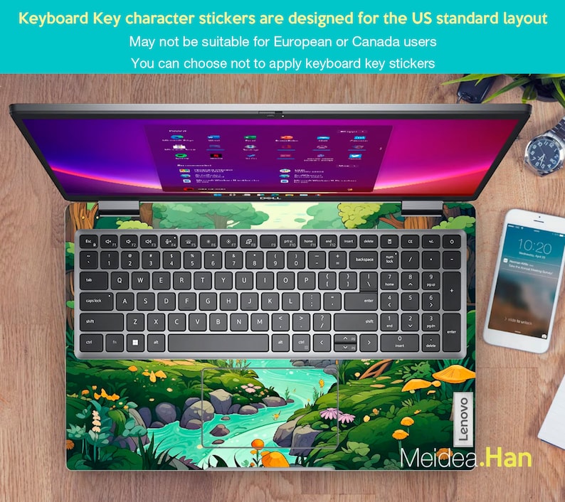 May include: A laptop computer with a green, blue, and yellow cartoon forest scene keyboard sticker. The sticker features a stream, trees, mushrooms, and flowers. The text "Lenovo" and "Meidea.Han" are visible on the laptop.