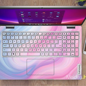 May include: A pink and blue laptop with a swirl design on the lid and a white keyboard. The laptop is open and the screen is showing a desktop with several icons. The text "Lenovo" is visible on the right side of the laptop. The text "Meidea.Han" is visible on the bottom right of the laptop.