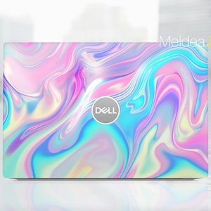 May include: A laptop computer with a holographic iridescent design. The laptop has a silver Dell logo on the lid.