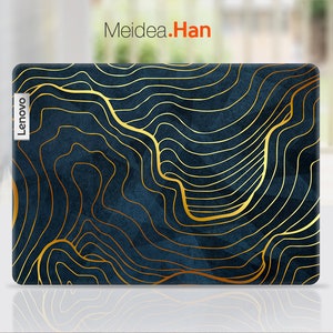 May include: A dark blue laptop skin with a gold abstract design. The skin has a textured look and features a gold outline of a mountain range. The Lenovo logo is visible on the left side of the skin.