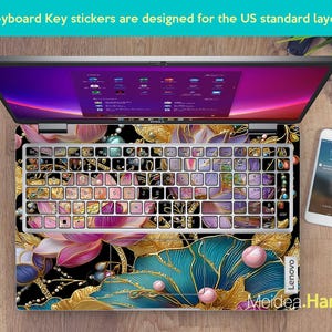 May include: Laptop with a keyboard overlay featuring a floral design in pink, gold, and teal. The keyboard keys are covered with decorative stickers. The text "Keyboard Key stickers are designed for the US standard layout" is visible.