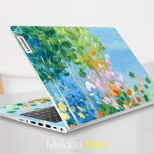 May include: A Lenovo laptop with a vibrant, artistic design. The laptop's cover features a colorful painting of trees and flowers against a blue sky. The keyboard is black, and the laptop is open on a white surface.